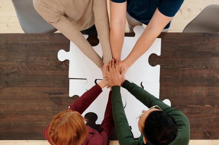 group of people joining hands