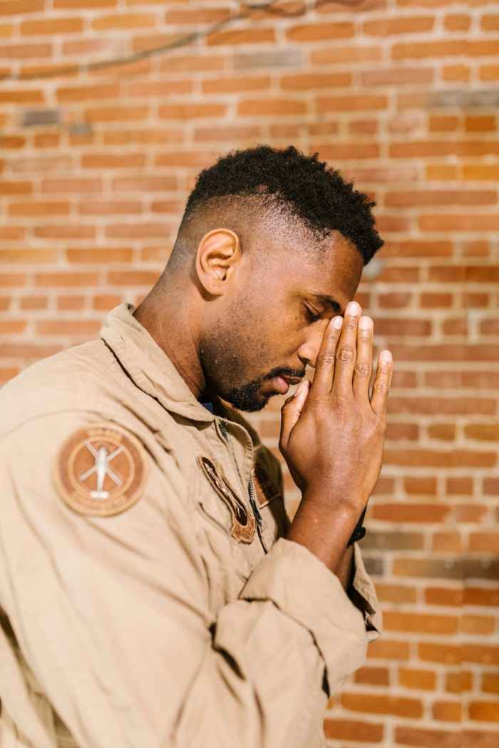 side view photo of praying man